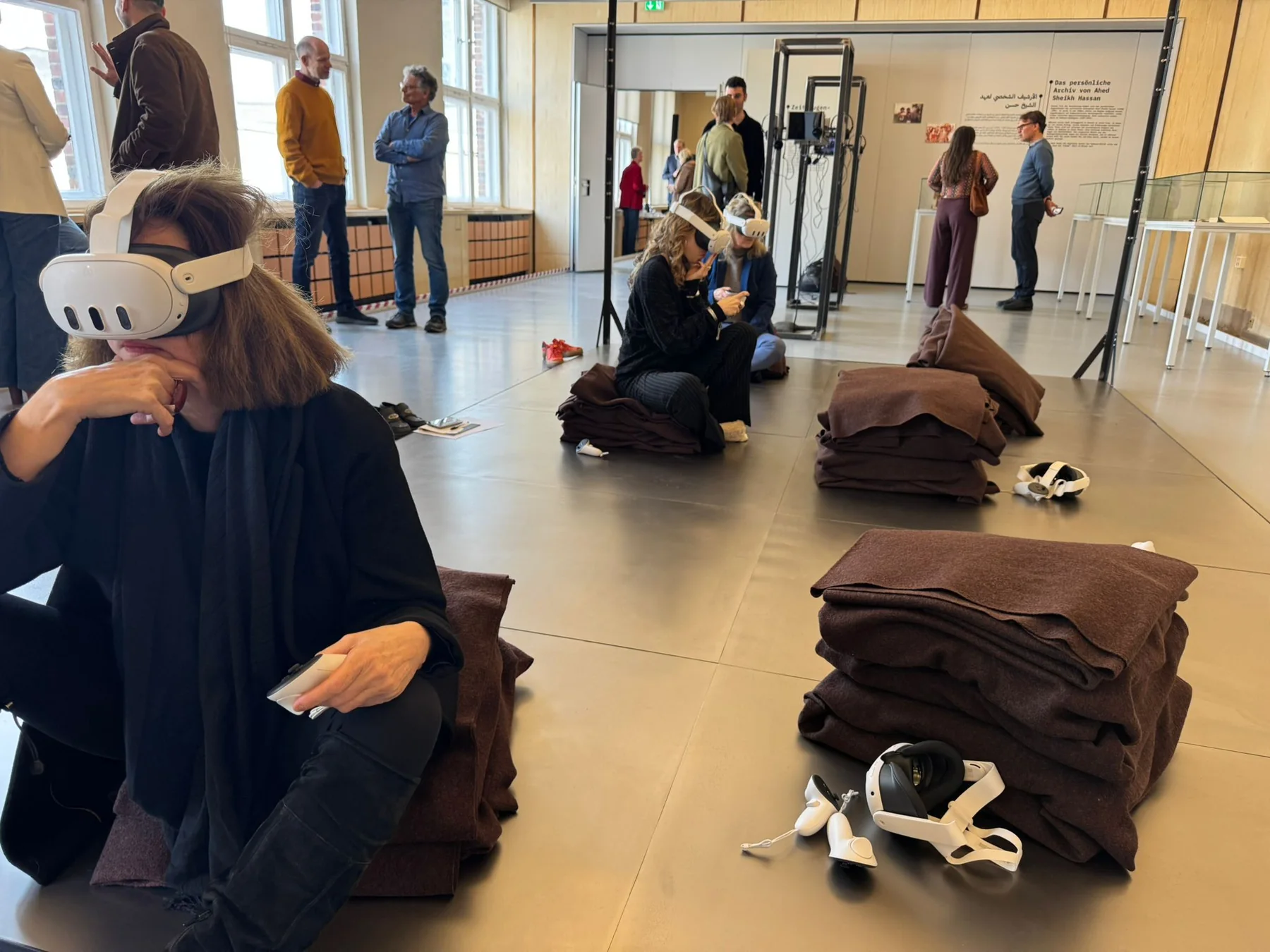 Visitors using virtual-reality headsets during a public tour of the Sednaya exhibition in Berlin
